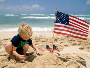 Boy with American Flags on a Beach