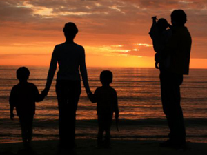 Family of 5 enjoying sunset at the seaside